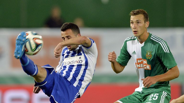 HJK's Erfan Zeneli (L) vies for ball with Rapid's Dominik Wydra (R) during the second leg play-off UEFA Europa League football match 