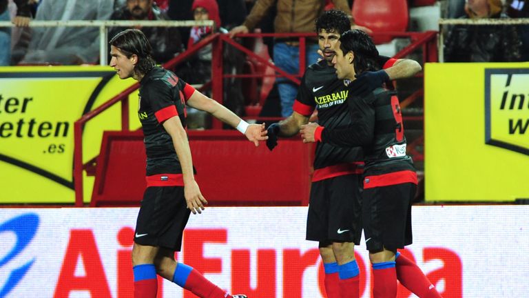 Atletico Madrid's Radamel Falcao (R) celebrates with Diego  Costa (C) and Filipe Luis (L) in 2013