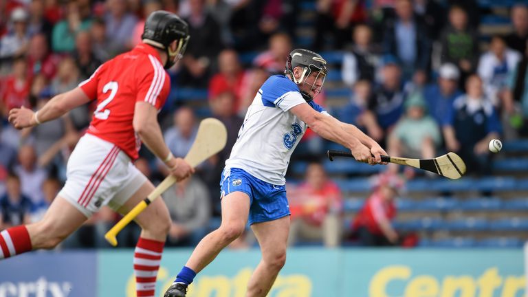 Jake Dillon score Waterford's second goal despite the efforts of Shane O'Neill