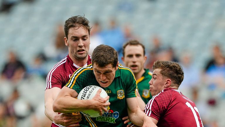 Meath's Padraic Harnan is tackled by Westmeath duo Darragh Daly and Ger Egan