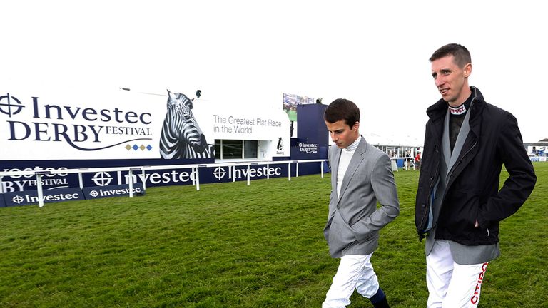 William Buick (l) and George Baker walk the course at Epsom June 05, 2015 in Epsom, England. (Photo b