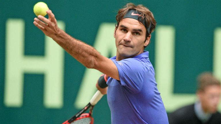 Roger Federer serves in his match against Ivo Karlovic during the Gerry Weber Open