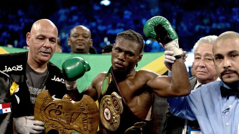 Nicholas Walters (C) of Jamaica celebrates defeating Vic Darchinyan (not seen) of Armenia during their WBA World Featherweight Title boxing match in Macau 