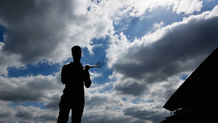 A groundsman works on the track ahead of day four at Royal Ascot