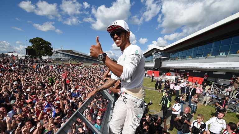 Lewis Hamilton celebrates with fans at Silverstone