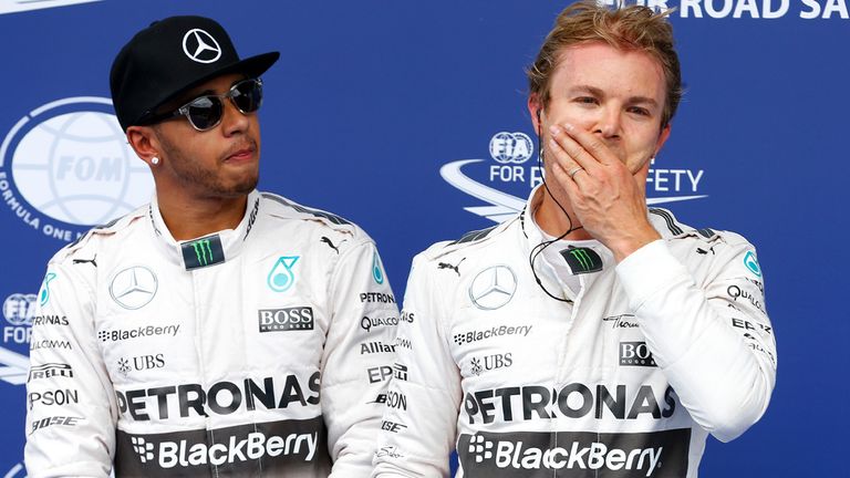 Lewis Hamilton stands next to Nico Rosberg of Germany in Parc Ferme after claiming pole in Austria