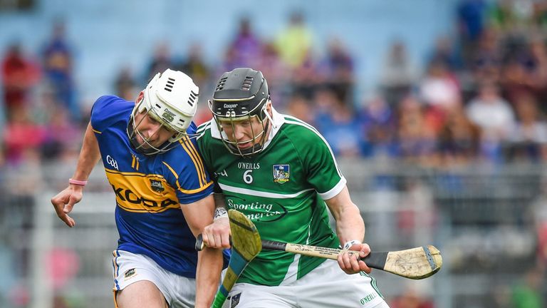 Tipperary's Patrick Maher is shouldered by Wayne McNamara of Limerick.