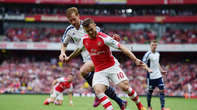 ack Wilshere of Arsenal and Craig Dawson of West Bromwich Albion compete for the ball