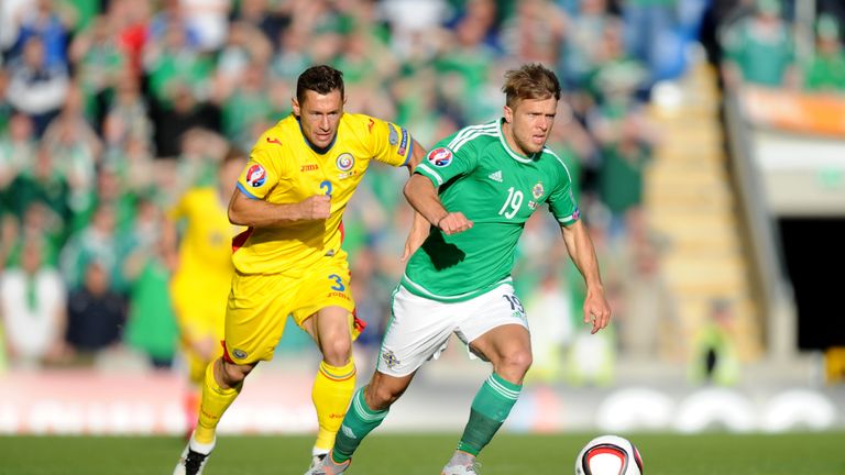 Northern Ireland's Jamie Ward and Romania's Laszlo Sepsi (left) battle for the ball during the UEFA European Championship Qualifying game at Windsor Park, 
