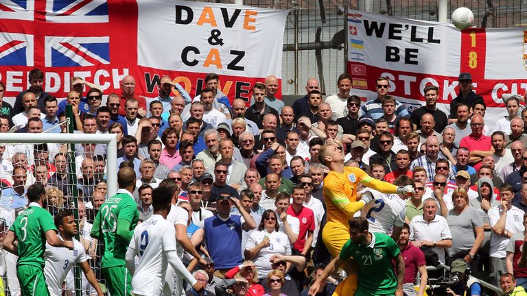 Joe Hart jumps to punch clear a cross