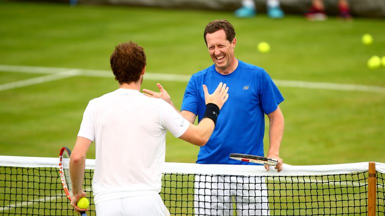Andy Murray of Great Britain shakes hands with his coach Jonas Bjorkman of Sweden during a practice session ahead of the Aegon Championships
