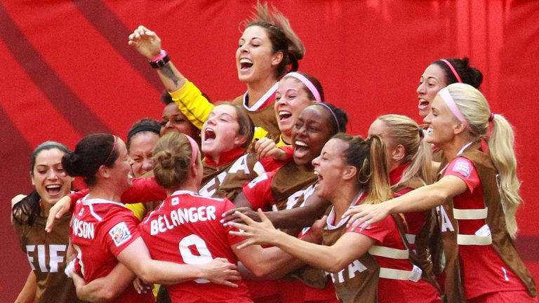 Josee Belanger is congratulated by her Switzerland team-mates after scoring