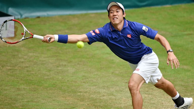 Kei Nishikori of Japan plays a forehand against Roger Federer at the Gerry Weber Open