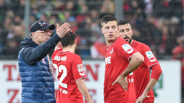 Cologne manager Peter Stoger gives instructions to Kevin Wimmer (second right)