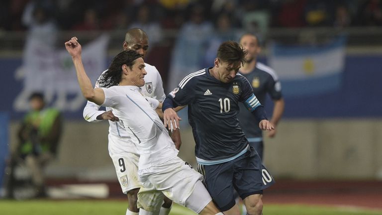 Uruguay's forward Edinson Cavani (L) marks Argentina's forward Lionel Messi