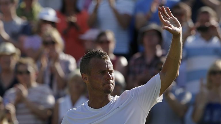 Australia's Lleyton Hewitt waves to the crowd after losing his men's singles first round match to Finland's Jarkko Nieminen