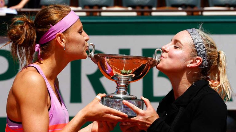 Lucie Safarova (left) and Bethanie Mattek-Sands kiss the French Open women's doubles trophy after victory at Roland Garros