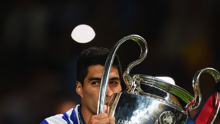 Luis Suarez of Barcelona kisses the trophy as he celebrates victory after the UEFA Champions League Final against Juventus in Berlin
