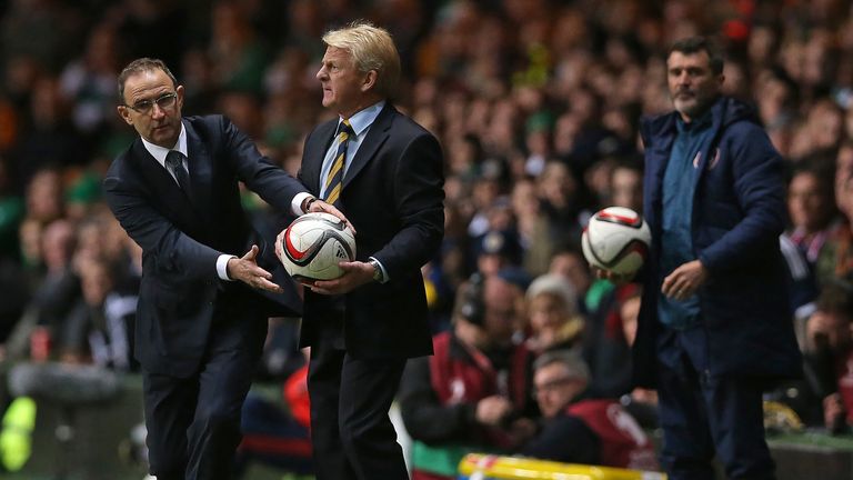 Scotland's manager Gordon Strachan (C) and Republic of Ireland's manager Martin O'Neill (L) vie for the ball as Republic of Ireland's assistant manager Roy