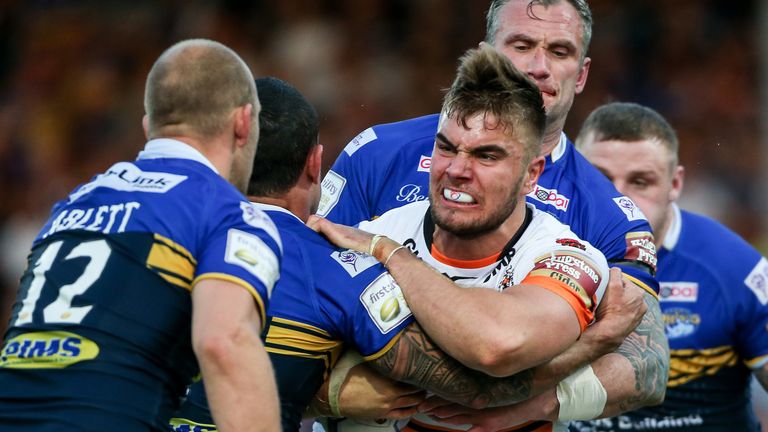 Mike McMeeken shows Castleford's determination as he  is tackled by Kylie Leuluai and Jamie Peacock