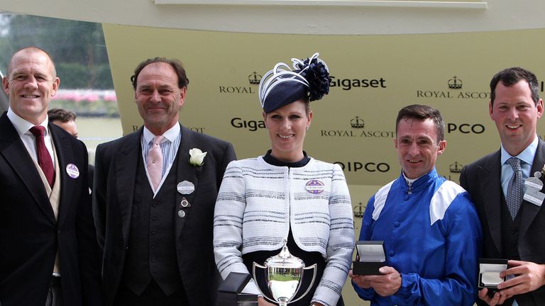 Jockey Dane O'Neill (second right) is presented the Commonwealth Cup by Zara Phillips (centre) after a winning ride on Muhaarar alongside racing manager An