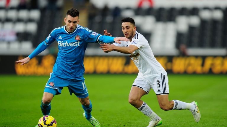Sunderland player Anthony Reveillere challenges Neil Taylor of Swansea City (r) 