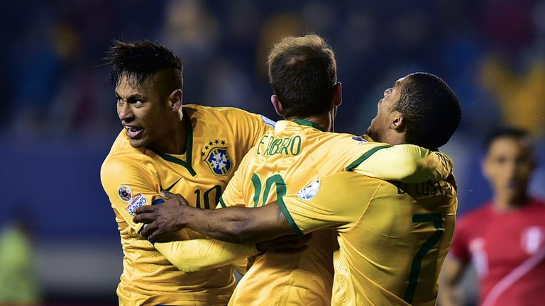 Brazil's midfielder Douglas Costa (R) celebrates with teammates Neymar (L) and Everton Ribeiro after scoring against Peru.