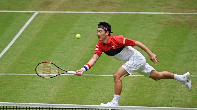 Kei Nishikori of Japan plays a forehand in his match against Dominic Thiem of Germany during day two of the Gerry Weber Open at Gerry Weber Stadium 