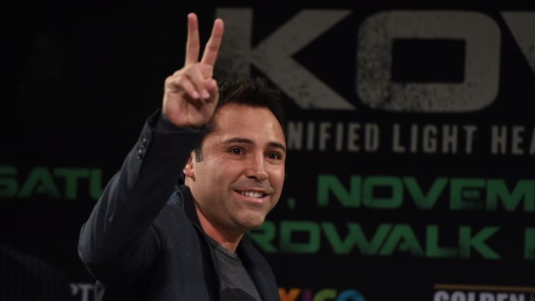 Former boxer and boxing promoter Oscar De La Hoya flashes a peace sign to the crowd before the weigh-in for the Hopkins vs Kovalev fight on November 7, 201