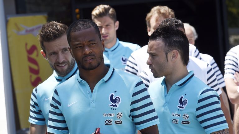 France's defender Patrice Evra (C), midfielder Yohan Cabaye (L) and forward Mathieu Valbuena leave their hotel