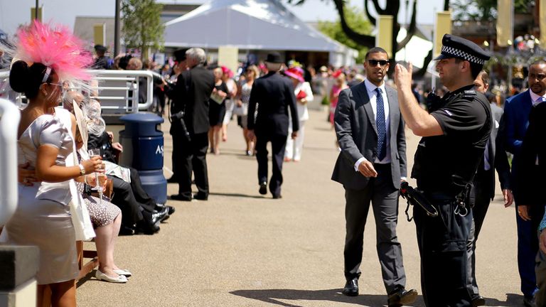 A police officer takes a photograph
