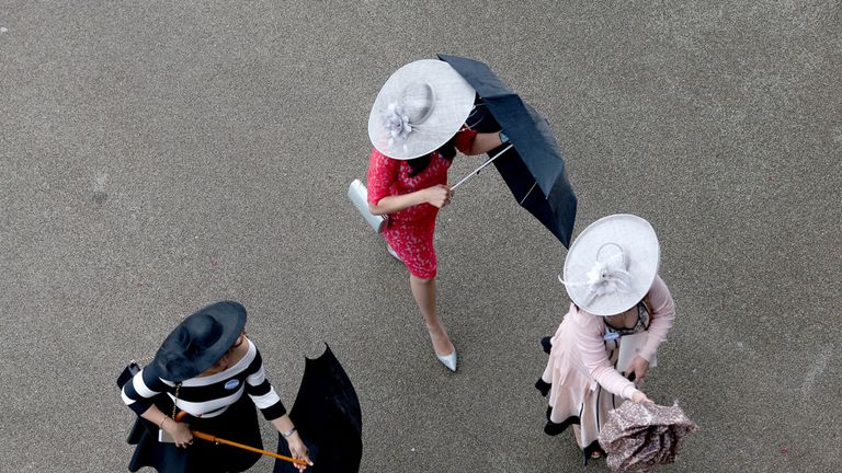 Racegoers with their umbrellas during day five of the 2015 Royal Ascot meeting 