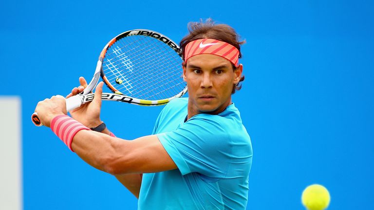 Rafael Nadal of Spain plays a backhand in his men's singles first round match against Alexandr Dolgopolov
