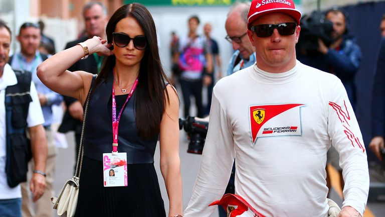 Kimi Raikkonen walks through the paddock with Minttu Virtanen after qualifying for the Monaco Formula