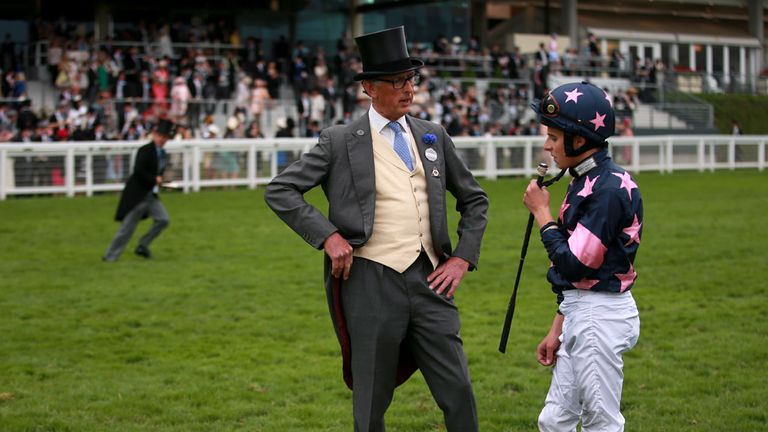 Jockey William Buick talks to trainer Roger Charlton during day five of the 2015 Royal Ascot Meeting.