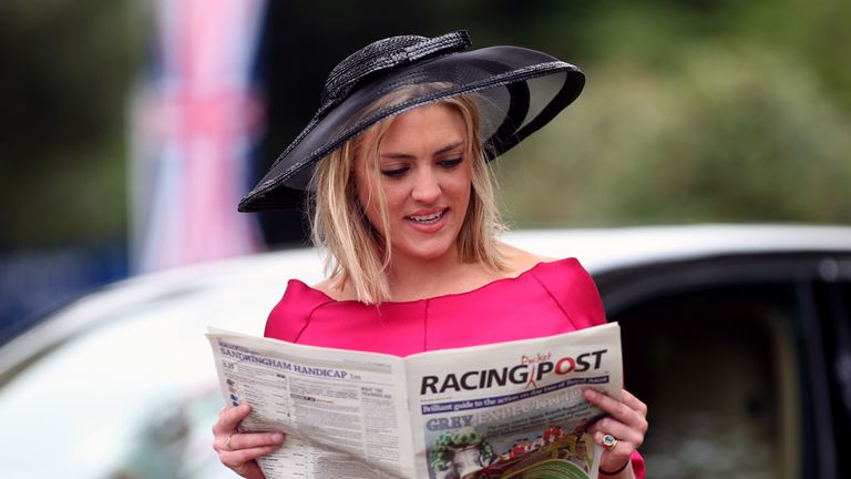 A racegoer checks the race cards and form in the Racing Post newspaper on day two of the 2015 Royal Ascot Meeting at Ascot Racecourse, Berkshire.