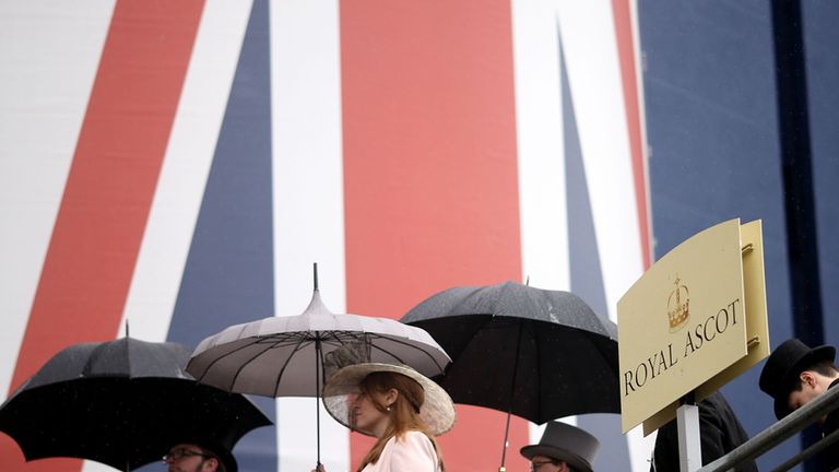 Racegoers holding umbrellas at Royal Ascot