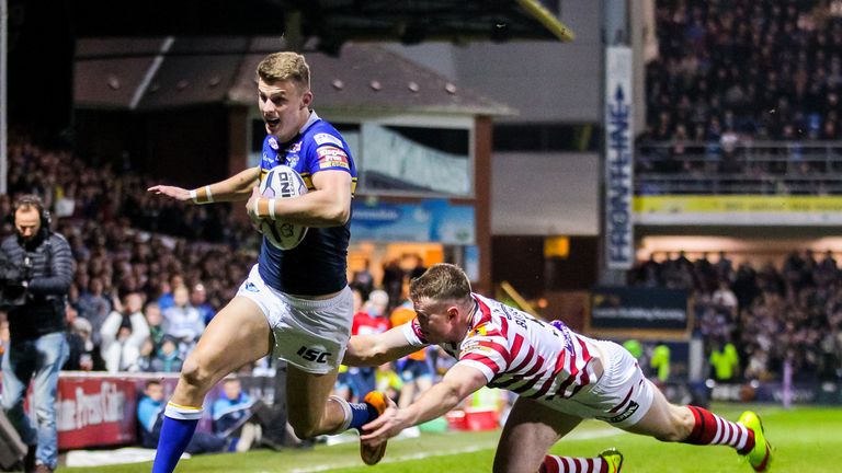 Leeds' Ash Handley escapes the tackle of Wigan's Joe Burgess to score a try
