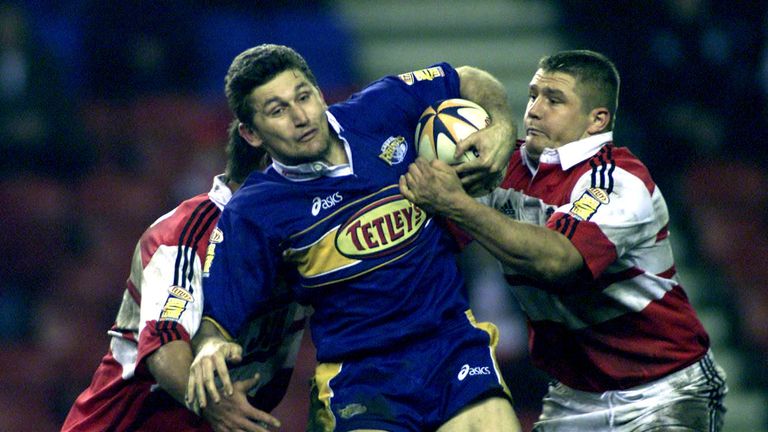 Wigan's Harvey Howard (left) and Terry Newton try to stop Leeds's Brett Mullins 2001