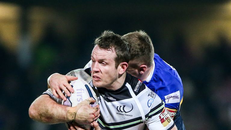 Widnes' Cameron Phelps is tackled by Leeds' Carl Ablett and Brad Singleton.