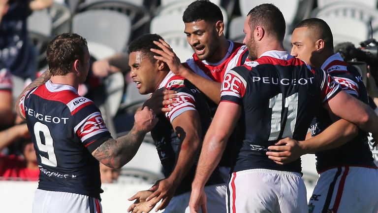 Michael Jennings of Sydney Roosters is congratulated after scoring a try against the Titans