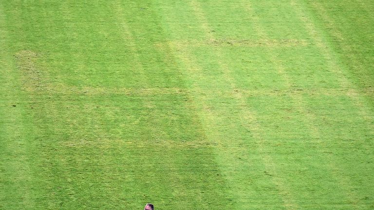 A man looks at the pitch appearing to show the pattern of a swastika following the the Euro 2016 qualifying football match between Croatia and Italy