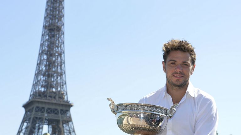 Stan Wawrinka poses with his Musketeers trophy in front of the Eiffel Tower in Paris