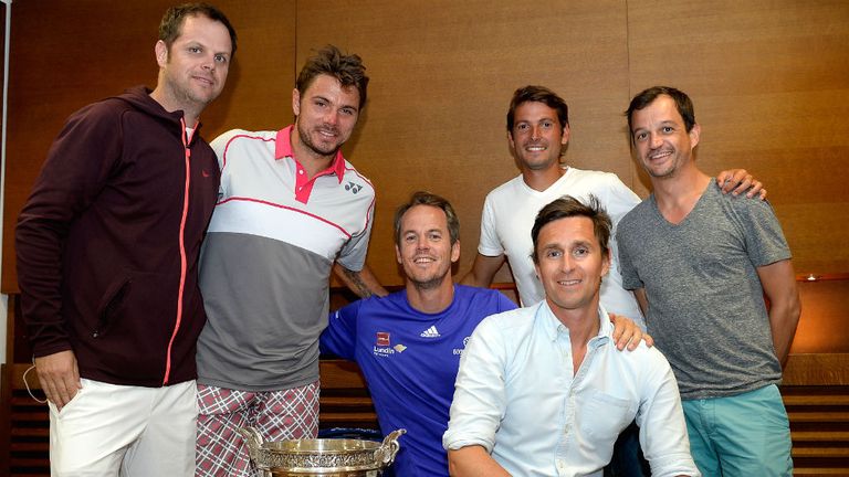 Stan Wawrinka poses with the Coupe de Mousquetaires and coaches Severin Luthi (L), Magnus Norman (C) and agent Lawrence Frankopan (front)