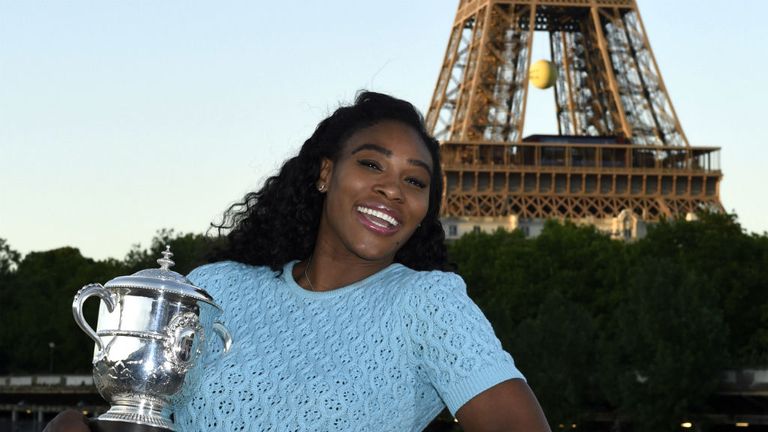 Serena Williams poses with her trophy near the Eiffel Tower after winning the women's final match of the Roland Garros 2015 French Open