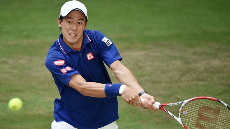 Kei Nishikori plays a backhand against Roger Federer at the Gerry Weber Open