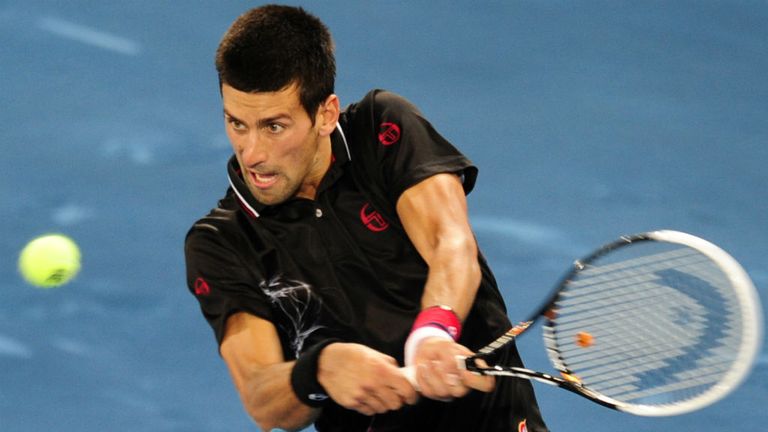Novak Djokovic returns a ball to Swiss Wawrinka during their Madrid Masters 2012 match at the Magic Box