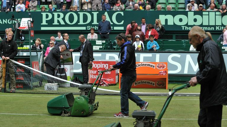 The grass is mowed before a second round match at the ATP Gerry Weber Open tennis tournament in Halle