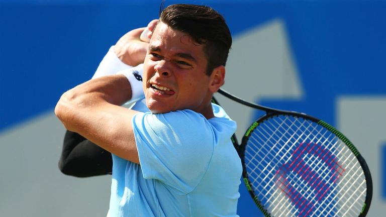 Milos Raonic plays a backhand in his men's singles quarter-final match against Gilles Simon at Queen's Club