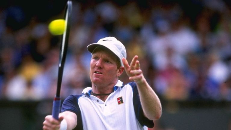 Jim Courier battles his way through a grueling five set match against Carlos Moya during Wimbledon